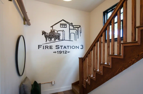 Interior of a stairway featuring a mural of a fire station with a horse-drawn fire truck, labeled "Fire Station 3, 1912."